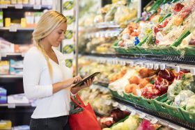 Woman in supermarket on tablet